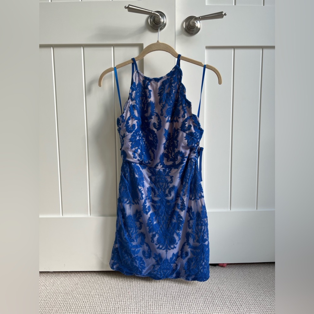 Blue lace mini dress! Never worn, tags still on. Beautiful color, cross backing.